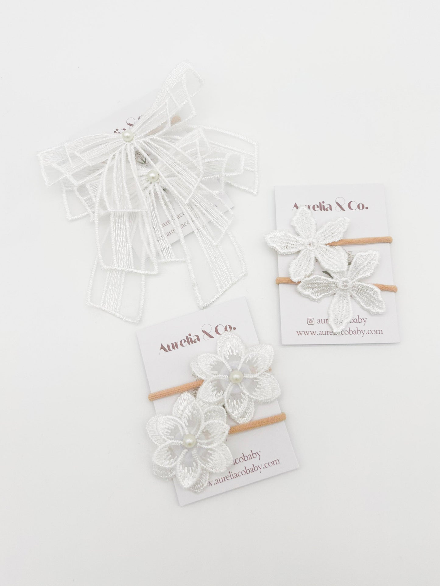 Set of floral hair ties with packaging on a white background